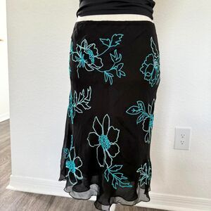 Black silk midi skirt with blue floral embroidery